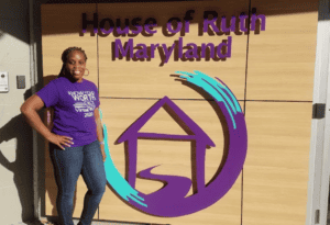 This is a picture of somebody standing in front of the House of Ruth's Baltimore office. 