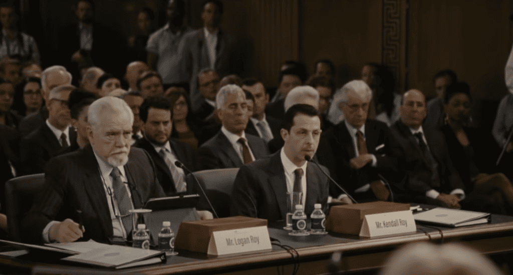 This is a screenshot of Succession's Logan Roy and Kendall Roy testifying before a congressional panel. 