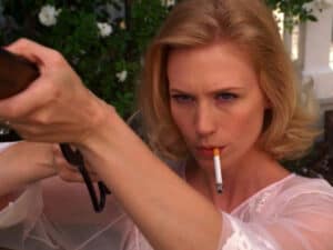 This is a photograph of Betty Draper of Mad Men shooting birds. 