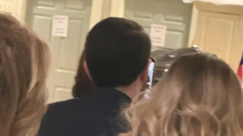 This is a photograph of former Congressman David J. Trone's chief of staff, Nathaniel McCarthy, recording Rep. April McClain Delaney at the 2026 Washington County Democratic Central Committee dinner on Saturday, February 21, 2026, in Hagerstown, Maryland.